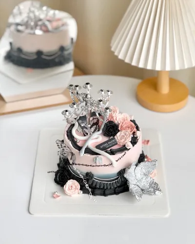 Elegant pink and black fondant cake with silver crown topper and handcrafted flowers for Mother’s Day