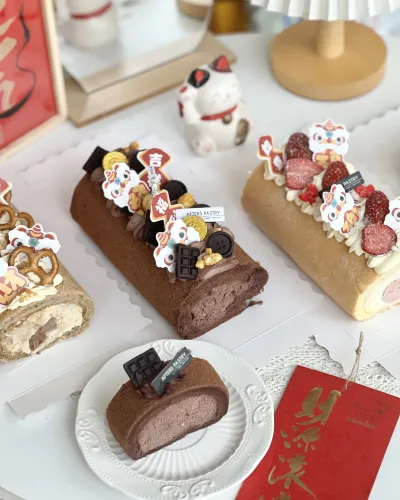 Chinese New Year roll cake with gold decoration and festive toppings