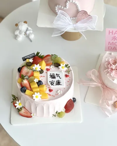 Mother’s Day fruit cake topped with strawberries, mangoes, and fresh cream