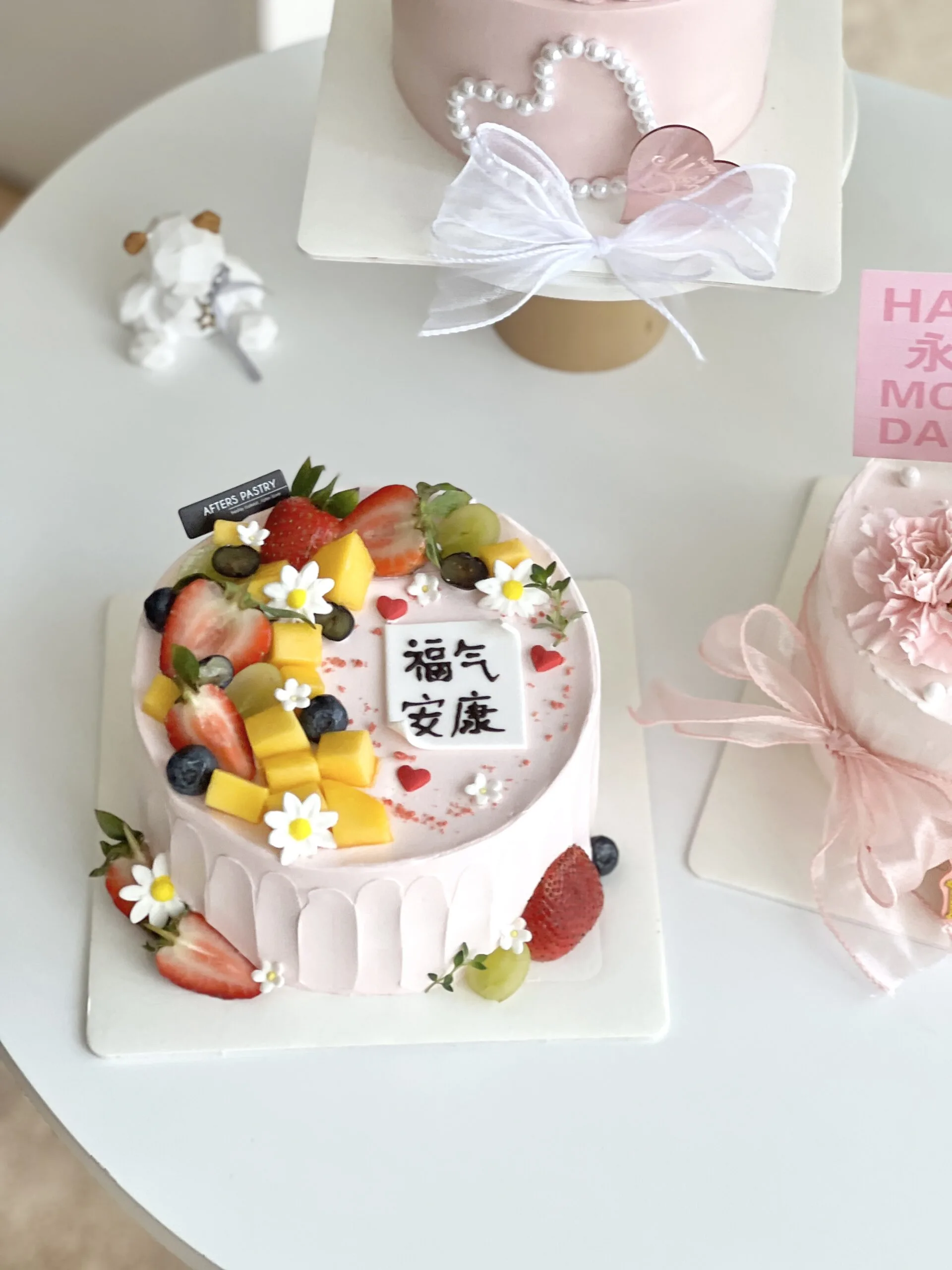Mother’s Day fruit cake topped with strawberries, mangoes, and fresh cream