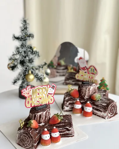 Christmas Chocolate Roll Cake with festive toppings and rich ganache