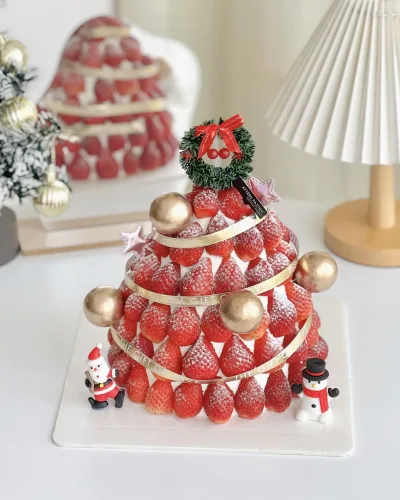 Christmas Strawberry Cake topped with fresh strawberries and holiday fondant decor