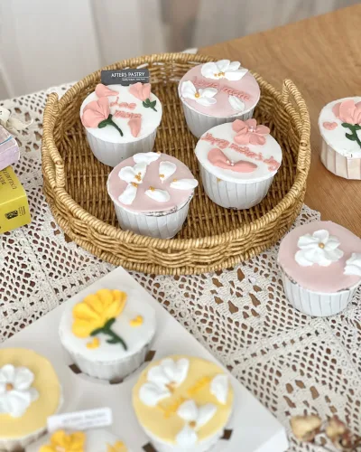 Customized cupcakes with edible toppers and themed decorations