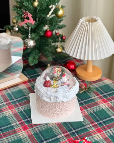 Snow Globe Christmas Cake with festive dome topper and five sponge flavours on a holiday table