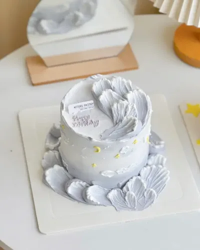 cloud dream birthday cake by Afters Pastry with sculpted buttercream clouds